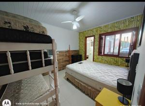 a bedroom with two bunk beds and a window at Casa ,piscina há 100 metros do mar ,24 pessoas in Capão da Canoa +43 photos