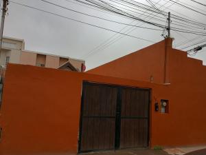 an orange building with a door on the side of it at Casa cerca de la playa in Ensenada +11 photos