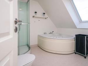 a bathroom with a shower and a toilet and a sink at Panoramic Golf View Retreat - By Traum Ferienwohnungen in Sønderby