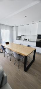 a large wooden table in a kitchen with chairs at Marco Polo Apartment in Nazaré