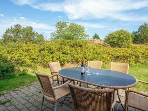 a table and chairs sitting on a patio at 6 person holiday home in Rømø in Sønderby
