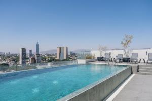 a large swimming pool on top of a building at Modern Stay in the Heart of Guadalajara in Guadalajara