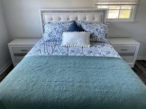 a bedroom with a blue bed with two night stands at Newnan Getaway in Newnan
