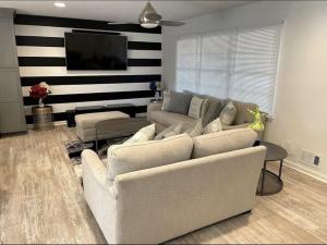 a living room with a couch and a flat screen tv at Newnan Getaway in Newnan