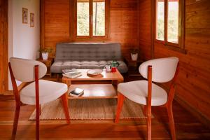 a living room with a couch and a table and chairs at Montecatini Ecolodge in Oxapampa