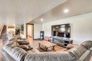 a living room with two couches and a tv at 4 Mi to Dtwn Sturgis Cabin with Hot Tub and Game Room in Crook City