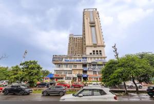 a large building with cars parked in a parking lot at Elite stay 4 in Greater Noida +8 photos
