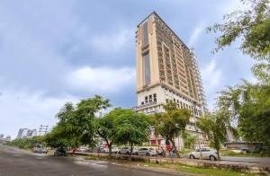 a tall building with cars parked in front of it at Elite stay 4 in Greater Noida