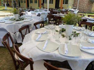 a group of tables with white plates and napkins at Hotel La Roca Costa Esmeralda in Monte Gordo