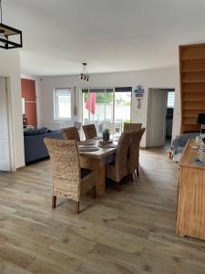 a dining room and living room with a table and chairs at brise marine in Le Crotoy