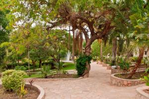 a park with a fountain and trees and a walkway at Lake Kariba Inns in Siavonga
