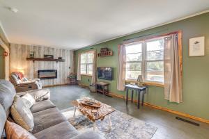 a living room with a couch and a table at Peaceful Cassville Vacation Rental - Hike and Fish! in Cassville