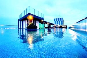 a large pool of water in front of a building at The Base Infinity in Pattaya Central