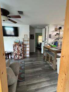 a kitchen with a table and a dining room at Blue Heron cottage in Gulfport