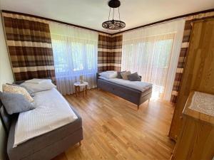 a living room with a bed and a couch at Apartamenty u Basi in Leśnica