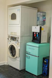 a laundry room with a washer and a microwave at Desert Dream Airstream in Yucca Valley