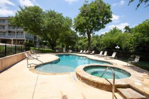 a small swimming pool with chairs around it at River Hippie RRC A302 in New Braunfels