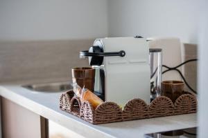 a coffee machine sitting on a counter with two cups at Bali Lodge - Evasion balinaise - Jaccuzzi - Sauna in Lens +11 photos