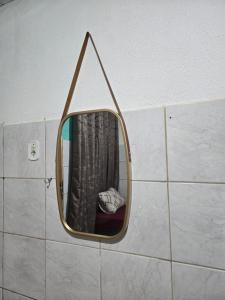 a mirror on a wall in a bathroom at Aluguel de quarto por diaria proximo ao aeroporto e rodoviaria in São Luís +9 photos