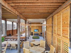 a wooden house with wooden walls and wooden tables and chairs at Pooldreamz! Beachfront Heated Salt Pool! Sleep24! in Caplen