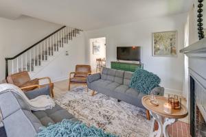 a living room with a couch and a tv at 3 Mi to Dtwn Updated Home with Hot Tub in Lexington in Lexington