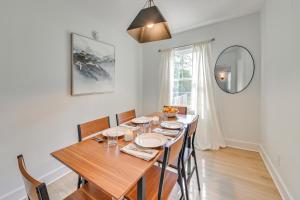 a dining room with a table with chairs and a mirror at 3 Mi to Dtwn Updated Home with Hot Tub in Lexington in Lexington