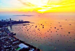 a group of kites in the water at sunset at The Edge Infinity in Pattaya