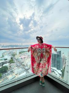 a woman standing on the ledge of a window at The Edge Infinity in Pattaya