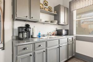 a kitchen with white cabinets and a sink at W38 Whole House in Cleveland