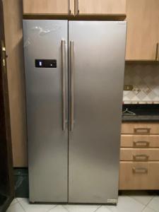 a stainless steel refrigerator in a kitchen at The Gardenia Villa Chic Escape with Pool in 6th Of October