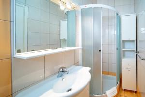 a bathroom with a sink and a mirror at Apartments with parking space Lopar, Rab - 24754 in Lopar