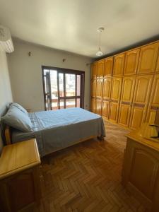 ein Schlafzimmer mit einem Bett und Holzschränken in der Unterkunft Casa de veraneio 2 dormitórios in Torres