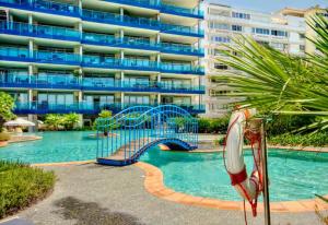 a pool with a slide in front of a building at Rock view Apartment at ocean village in Gibraltar +7 photos