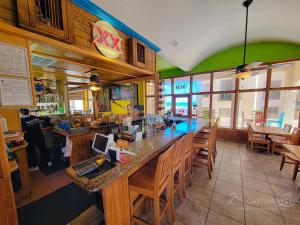 un ristorante con un ampio bar con tavoli e sedie in legno di Sonoran Spa W106 a Campo del Medio