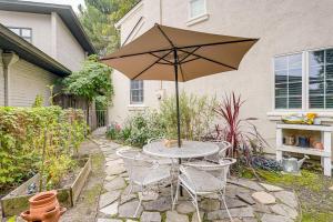 a table and chairs with an umbrella in a yard at Walkable Miracle Mile Retreat with Peaceful Patio in Stockton