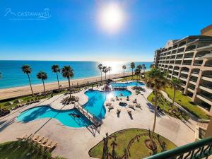 a view of the beach from the balcony of a resort at Sonoran Spa E509 in Campo del Medio