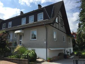 a house with a black and white roof at Haus Roswita in Bad Harzburg