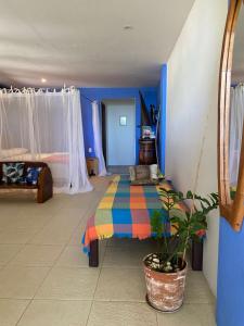 a bedroom with a bed with a colorful blanket at Loft Sol Nascente in Itacaré