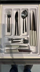 a plastic container with utensils in a drawer at Studios Gago 167 in Suzano