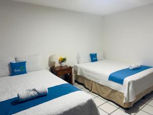 two beds sitting next to each other in a room at Hotel Ocean View in San Juan del Sur +30 photos