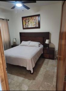 a bedroom with a bed and a painting on the wall at Condo Ventanas El Arco Views & Pool in Cabo San Lucas