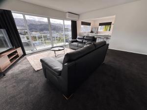 Una sala de estar con un sofá y un televisor. en Seaview Retreat, en Picton
