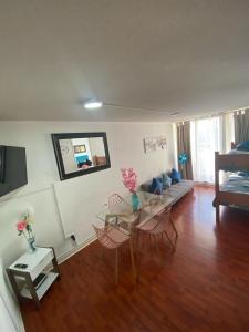 ein Wohnzimmer mit Tisch, Stühlen und Sofa in der Unterkunft santiago apart in Santiago