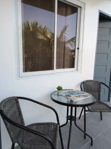 a patio with a table and chairs and a window at Casita Angela in Panglao