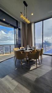 a dining room with a table and chairs and the ocean at The Grand in Suva