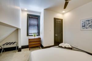 a bedroom with a bed and a dresser and a window at Walk to Tower Grove Park St Louis Getaway in Tower Grove