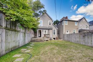 a backyard with a fence and a house at Walk to Tower Grove Park St Louis Getaway in Tower Grove