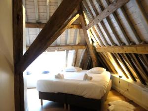 a bedroom with a bed in an attic at Historic Gardener s House in Haltinne in Haltinne