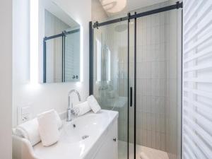 a white bathroom with a shower and a sink at Historic Gardener s House in Haltinne in Haltinne +19 photos