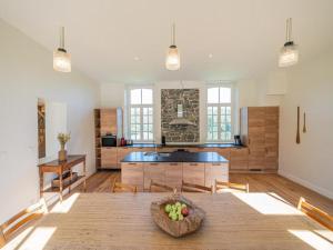 a kitchen with a wooden table with a bowl of fruit at Historic Gardener s House in Haltinne in Haltinne